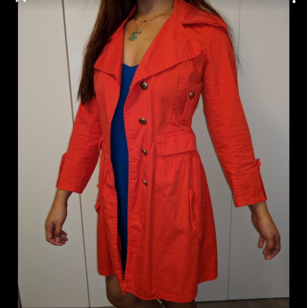 Bright red-orange trench coat.